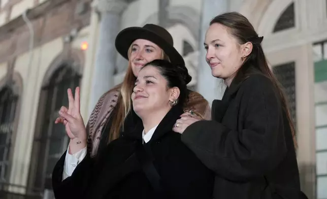 Rescue volunteers celebrate outside a courthouse in Mytilene, on the northeastern Aegean island of Lesbos, Greece, Thursday, Jan. 15, 2026, after being acquitted of charges related to aiding migrants. (AP Photo/Panagiotis Balaskas)