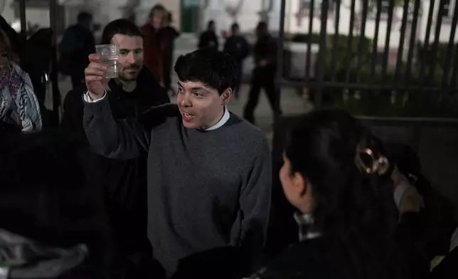 Sean Binderm, one of 24 rescue volunteers, celebrates outside a courthouse in Mytilene, on the northeastern Aegean island of Lesbos, Greece, Thursday, Jan. 15, 2026, after being acquitted of charges related to aiding migrants. (AP Photo/Panagiotis Balaskas)