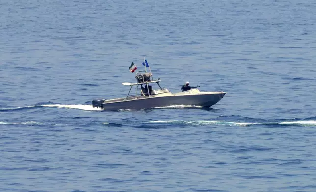 FILE - An Iranian Revolutionary Guard vessel watches an American warship in the Strait of Hormuz, May 19, 2023. (AP Photo/Jon Gambrell, File)