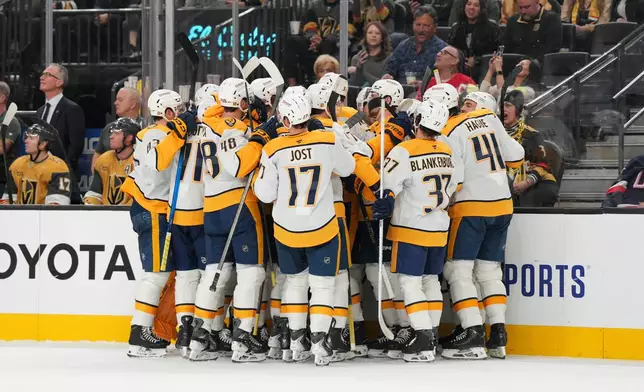 Nashville Predators celebrate Nashville Predators center Steven Stamkos' 600th career goal during the first period of an NHL hockey game against the Vegas Golden Knights, Wednesday, Dec. 31, 2025, in Las Vegas. (AP Photo/Candice Ward)