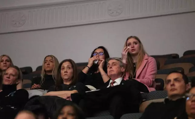 Attendees at an event honoring the 67 lives lost in the 2025 midair collision near DCA airport, Wednesday, Jan. 28, 2026, in Washington. (AP Photo/Allison Robbert)