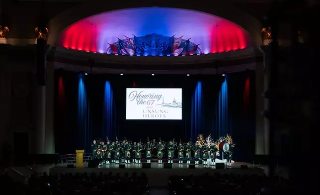 D.C. Fire Department Pipes and Drums perform at an event honoring the 67 lives lost in the 2025 midair collision near DCA airport, Wednesday, Jan. 26, 2026, in Washington. (AP Photo/Allison Robbert)