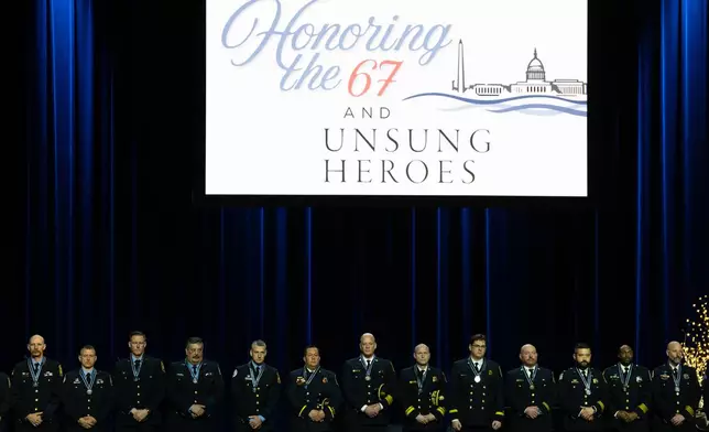 First responders accept medals at an event honoring the 67 lives lost in the 2025 midair collision near DCA airport, Wednesday, Jan. 28, 2026, in Washington. (AP Photo/Allison Robbert)