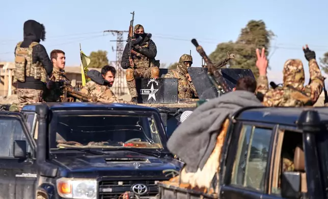 Soldiers of the Kurdish-led, U.S.-backed Syrian Democratic Forces (SDF) deploy with armoured military vehicles to secure roads leading to Gweiran Prison which houses men accused of being an Islamic State (ISIS) fighters in Hassakeh, northeastern Syria, Monday, Jan. 19, 2026. (AP Photo/Baderkhan Ahmad)