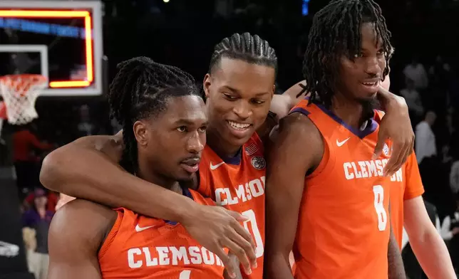 Clemson's guard Jestin Porter (1) forward RJ Godfrey (0) and forward Dallas Thomas (8) react after a win after an NCAA college basketball game against Georgia Tech, Saturday, Jan. 24, 2026, in Atlanta. (AP Photo/Brynn Anderson)