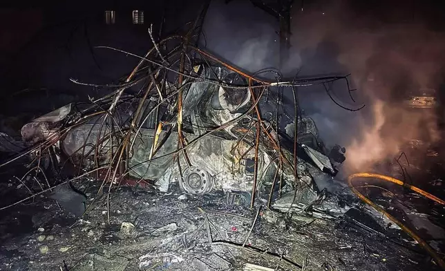 This photo provided by the Ukrainian Emergency Service, shows a burned car after Russian attack in Zaporizhzhia, Ukraine, Wednesday, Jan. 28, 2026. (Ukrainian Emergency Service via AP Photo)
