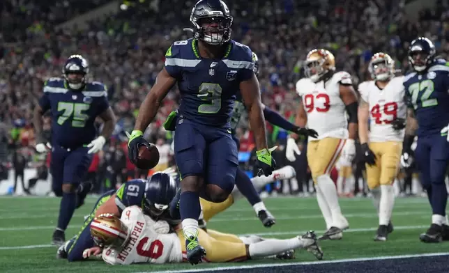 Seattle Seahawks running back Kenneth Walker III (9) scores a touchdown during the second half of an NFL football divisional playoff game against the San Francisco 49ers, Saturday, Jan. 17, 2026, in Seattle. (AP Photo/Lindsey Wasson)