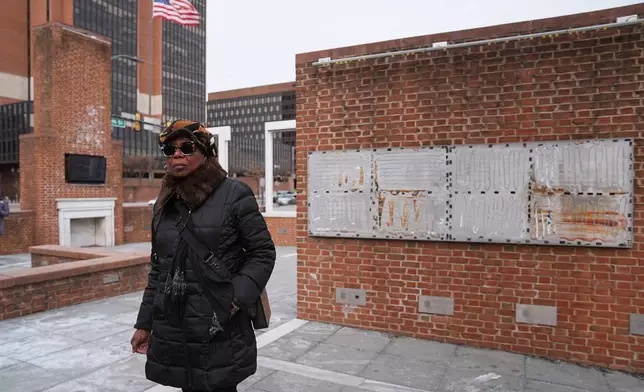 Karen Oliver walks by the locations of a now removed explanatory panels that were part of an exhibit on slavery at President's House Site in Philadelphia, Friday, Jan. 23, 2026. (AP Photo/Matt Rourke)