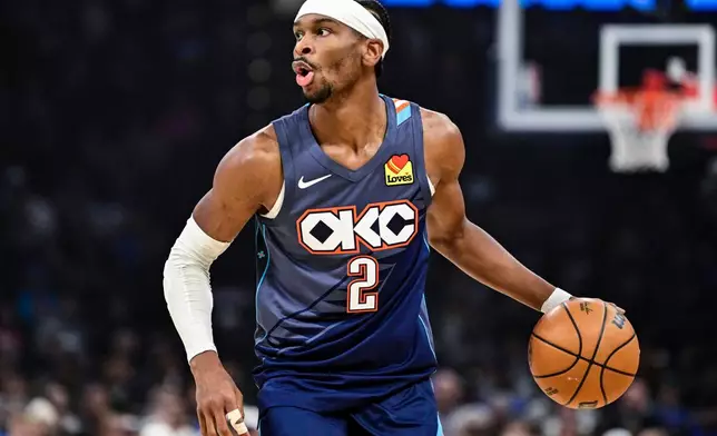 Oklahoma City Thunder guard Shai Gilgeous-Alexander drives the ball against the Indiana Pacers during the first half of an NBA basketball game Friday, Jan. 23, 2026, in Oklahoma City. (AP Photo/Gerald Leong)