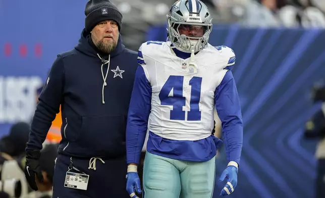 Dallas Cowboys defensive end Donovan Ezeiruaku (41) leaves the game after being disqualified during the third quarter of an NFL football game against the New York Giants, Sunday, Jan. 4, 2026, in East Rutherford, N.J. (AP Photo/Adam Hunger)