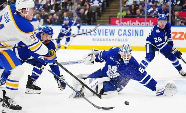 Toronto Maple Leafs goaltender Joseph Woll (60) stops Buffalo Sabres' Josh Doan (91) during third period NHL action in Toronto on Tuesday, Jan. 27, 2026. (Frank Gunn/The Canadian Press via AP)
