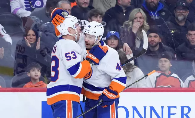 New York Islanders' Jean-Gabriel Pageau, right, and Casey Cizikas celebrate after Pageau's goal during the first period of an NHL hockey game against the Philadelphia Flyers Monday, Jan. 26, 2026, in Philadelphia. (AP Photo/Matt Slocum)