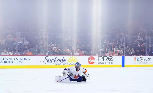 New York Islanders' Ilya Sorokin stretches during the second period of an NHL hockey game against the Philadelphia Flyers Monday, Jan. 26, 2026, in Philadelphia. (AP Photo/Matt Slocum)