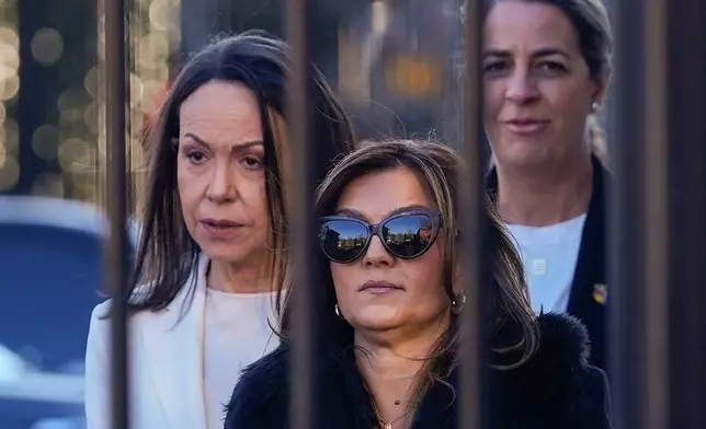 Venezuelan opposition leader María Corina Machado, left, leaving the White House in Washington, after meeting with President Donald Trump Thursday, Jan. 15, 2026. (AP Photo/Pablo Martinez Monsivais)