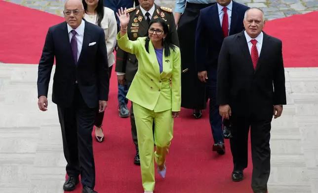 Venezuela's acting President Delcy Rodriguez, center, National Assembly President Jorge Rodriguez, left, and Interior Minister Diosdado Cabello arrive at the National Assembly in Caracas, Venezuela, Thursday, Jan. 15, 2026. (AP Photo/Ariana Cubillos)