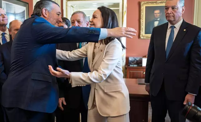 Venezuelan opposition leader Maria Corina Machado reaches out to embrace Sen. Ted Cruz, R-Texas, left, as the Nobel Peace Prize recipient meets with Sen. Alex Padilla, D-Calif., right, and others two weeks after President Donald Trump toppled Venezuelan president Nicolas Maduro in a stunning military raid, at the Capitol in Washington, Thursday, Jan. 15, 2026. (AP Photo/J. Scott Applewhite)