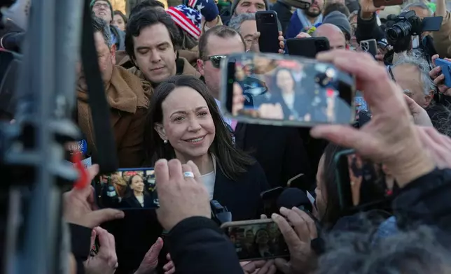 Venezuelan opposition leader María Corina Machado, center, leaves the Capitol, Thursday, Jan. 15, 2026, in Washington. (AP Photo/Allison Robbert)