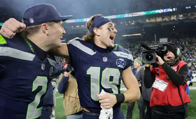 Seattle Seahawks wide receiver Jake Bobo (19) celebrates with quarterback Drew Lock (2) after the NFC Championship NFL football game against the Los Angeles Rams, Sunday, Jan. 25, 2026, in Seattle. (AP Photo/John Froschauer)