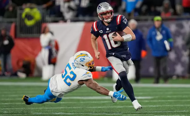 New England Patriots quarterback Drake Maye (10) avoids a tackle by Los Angeles Chargers linebacker Khalil Mack (52) in the first half of an NFL wild-card playoff football game in Foxborough, Mass., Sunday, Jan. 11, 2026. (AP Photo/Charles Krupa)