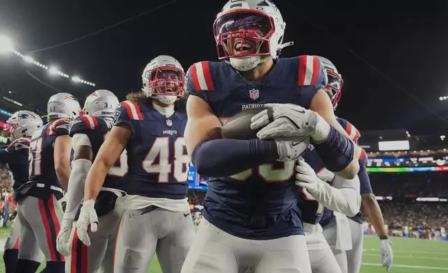 New England Patriots linebacker Christian Elliss celebrates after recovering a fumble by Los Angeles Chargers quarterback Justin Herbert in the second half of an NFL wild-card playoff football game in Foxborough, Mass., Sunday, Jan. 11, 2026. (AP Photo/Charles Krupa)