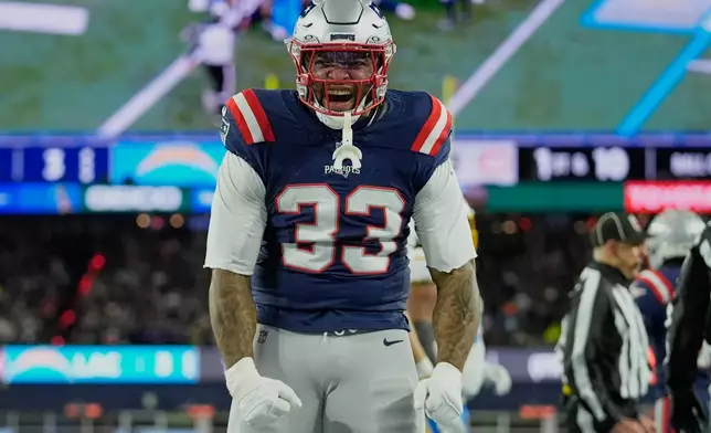 New England Patriots linebacker Anfernee Jennings (33) celebrates a tackle in the first half of an NFL wild-card playoff football game against the Los Angeles Chargers, in Foxborough, Mass., Sunday, Jan. 11, 2026. (AP Photo/Robert F. Bukaty)