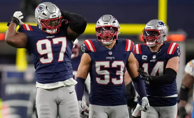 New England Patriots defensive end Milton Williams (97), linebacker Christian Elliss (53) and linebacker Robert Spillane (14) celebrate Williams' sack of Los Angeles Chargers quarterback Justin Herbert (10) in the second half of an NFL wild-card playoff football game in Foxborough, Mass., Sunday, Jan. 11, 2026. (AP Photo/Charles Krupa)