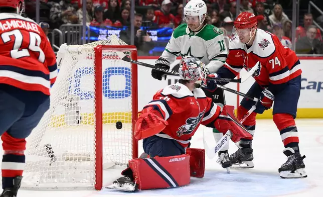 Dallas Stars center Sam Steel (18) scores a goal past Washington Capitals goaltender Logan Thompson (48) and defenseman John Carlson (74) during the second period of an NHL hockey game, Wednesday, Jan. 7, 2026, in Washington. (AP Photo/Nick Wass)