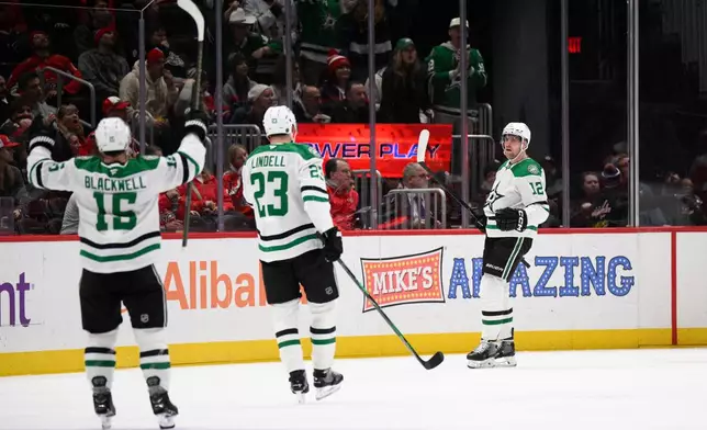 Dallas Stars center Radek Faksa (12) celebrates his goal with center Colin Blackwell (15) and defenseman Esa Lindell (23) during the first period of an NHL hockey game against the Washington Capitals, Wednesday, Jan. 7, 2026, in Washington. (AP Photo/Nick Wass)