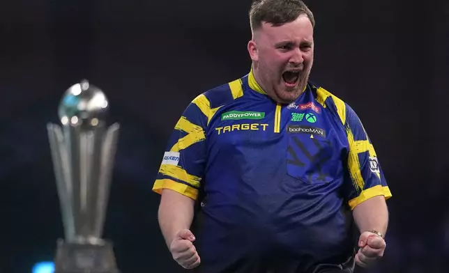 England's Luke Littler reacts after winning the World Darts Championships final match against Gian van Veen of the Netherlands at Alexandra Palace in London, Saturday, Jan. 3, 2026.(AP Photo/Dave Shopland)