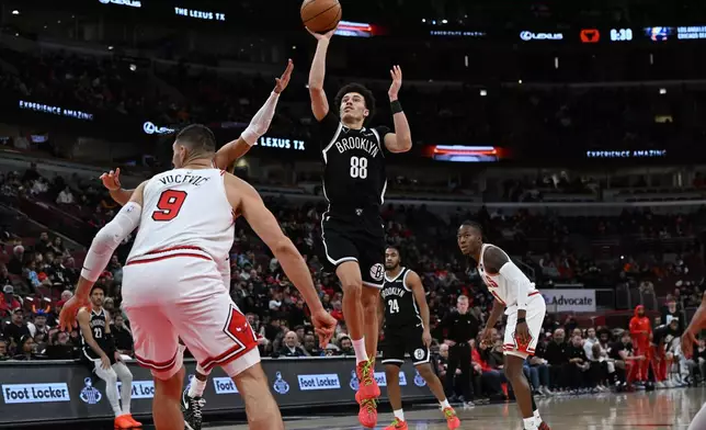 Brooklyn Nets' Nolan Traore (88) goes up for a shot during the first half of an NBA basketball game against the Chicago Bulls, Sunday, Jan. 18, 2026, in Chicago. (AP Photo/Paul Beaty)