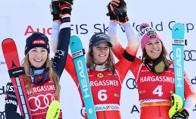Switzerland's Camille Rast, center, winner of an alpine ski, women's World Cup slalom, poses with second placed United States' Mikaela Shiffrin, left, and third placed Switzerland's Wendy Holdener, in Kranjska Gora, Slovenia, Sunday, Jan. 4, 2026. (AP Photo/Marco Trovati)