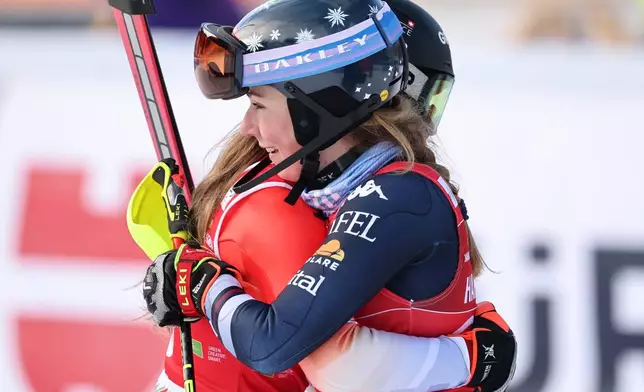 Switzerland's Camille Rast, left, winner of an alpine ski, women's World Cup slalom, is congratulated by second placed United States' Mikaela Shiffrin, in Kranjska Gora, Slovenia, Sunday, Jan. 4, 2026. (AP Photo/Marco Trovati)