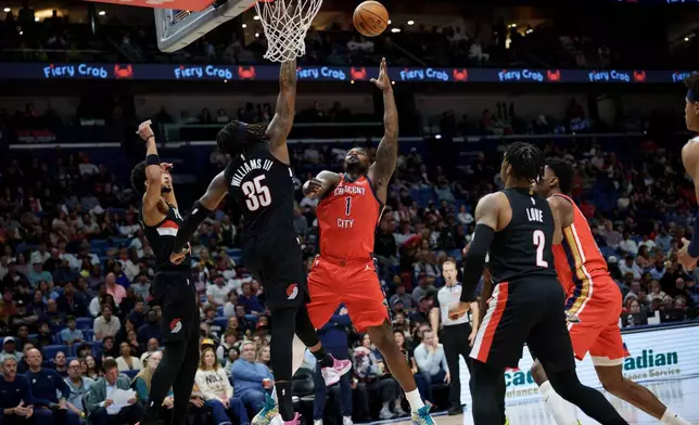 New Orleans Pelicans forward Zion Williamson (1) shoots against Portland Trail Blazers center Robert Williams III (35) during the first half of an NBA basketball game in New Orleans, Friday, Jan. 2, 2026. (AP Photo/Matthew Hinton)