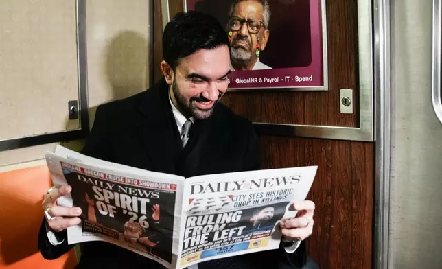 New York City Mayor Zohran Mamdani reads a newspaper on the subway on his way to City Hall in New York, Friday, Jan. 2, 2026. (AP Photo/Eduardo Munoz Alvarez)