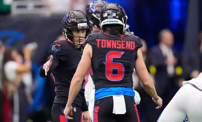 Houston Texans place kicker Ka'imi Fairbairn, left, celebrates after a field goal against the Indianapolis Colts during the second half of an NFL football game in Houston, Sunday, Jan. 4, 2026. (AP Photo/David J. Phillip)