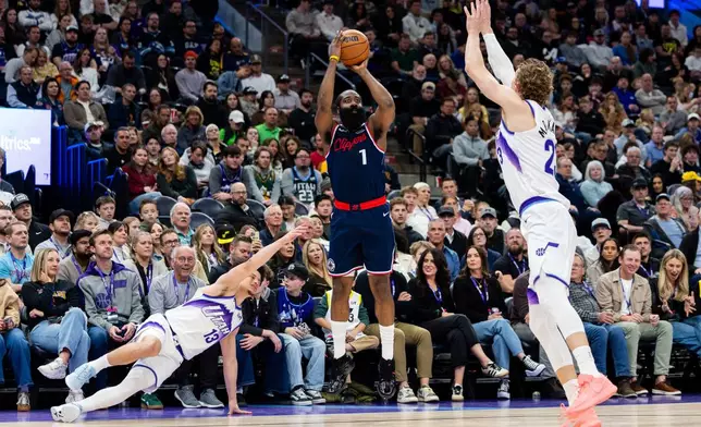 Utah Jazz guard Walter Clayton Jr. (13) and forward Lauri Markkanen, right, attempt to defend Los Angeles Clippers guard James Harden (1) as he shoots during the second half of an NBA basketball game, Tuesday, Jan. 27, 2026, in Salt Lake City. (AP Photo/Anna Fuder)