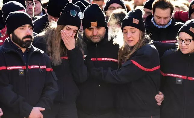 Firefighters cry as they attend a memorial march in Crans-Montana, Swiss Alps, Switzerland, Sunday, Jan. 4, 2026, after a devastating fire in Le Constellation bar left dead and injured during the New Year's celebrations. (AP Photo/Baz Ratner)