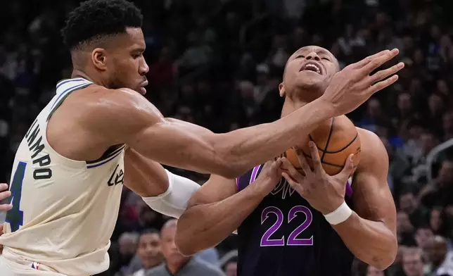 Milwaukee Bucks' Giannis Antetokounmpo fouls Minnesota Timberwolves' Jaylen Clark during the first half of an NBA basketball game Tuesday, Jan. 13, 2026, in Milwaukee. (AP Photo/Morry Gash)