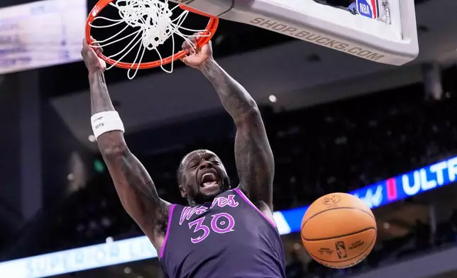Minnesota Timberwolves' Julius Randle dunks during the first half of an NBA basketball game against the Milwaukee Bucks Tuesday, Jan. 13, 2026, in Milwaukee. (AP Photo/Morry Gash)