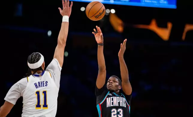 Memphis Grizzlies forward Cedric Coward (23) shoots against Los Angeles Lakers center Jaxson Hayes (11) during the first half of an NBA basketball game Sunday, Jan. 4, 2026, in Los Angeles. (AP Photo/Ethan Swope)