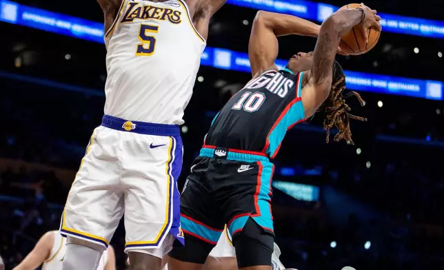 Memphis Grizzlies guard Javon Small (10) shoots against Los Angeles Lakers center Deandre Ayton (5) during the first half of an NBA basketball game Sunday, Jan. 4, 2026, in Los Angeles. (AP Photo/Ethan Swope)
