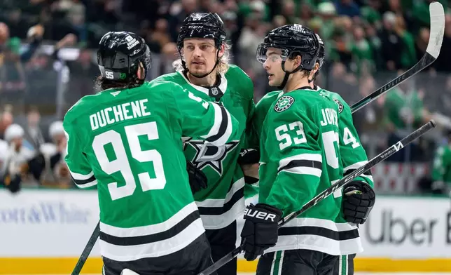 Dallas Stars center Matt Duchene (95), center Roope Hintz, second from left, center Wyatt Johnston (53) and defenseman Miro Heiskanen (4) celebrate Johnston's goal during the first period of an NHL hockey game against the Boston Bruins, Tuesday, Jan. 20, 2026, in Dallas. (AP Photo/Jeffrey McWhorter)
