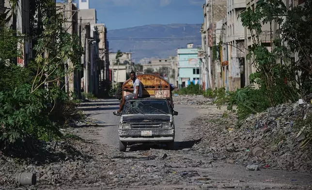 A local travels on public transportation through a gang-controlled area of Port-au-Prince, Haiti, Monday, Jan. 19, 2026. (AP Photo/Odelyn Joseph)