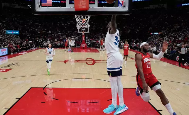 Minnesota Timberwolves forward Julius Randle (30) dunks during the first half of an NBA basketball game against the Houston Rockets in Houston, Friday, Jan. 16, 2026. (AP Photo/Ashley Landis)