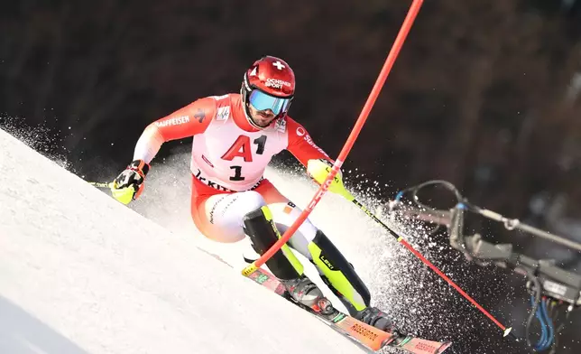 Switzerland's Loic Meillard speeds down the course during an alpine ski, men's World Cup slalom in Kitzbuehel, Austria, Sunday, Jan. 25, 2026. (AP Photo/Marco Trovati)