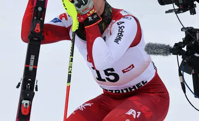 Austria's Manuel Feller reacts after winning an alpine ski, men's World Cup slalom in Kitzbuehel, Austria, Sunday, Jan. 25, 2026. (AP Photo/Marco Trovati)