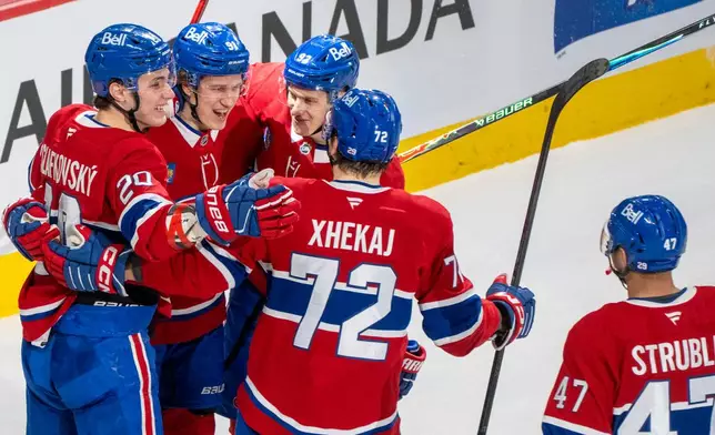 Montreal Canadiens' Oliver Kapanen (91) celebrates his goal over Florida Panthers with teammates Juraj Slafkovsky (20), Ivan Demidov (93), Arber Zhekaj (72) and Jayden Struble (47) during the first period of an NHL hockey game in Montreal, Thursday, Jan. 8, 2026. (Christinne Muschi/The Canadian Press via AP)