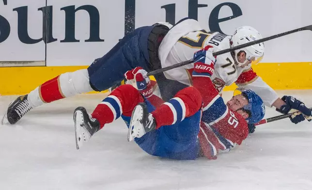 Montreal Canadiens' Alexandre Texier (85) is tripped up by Florida Panthers' Niko Mikkola (77) during the first period of an NHL hockey game in Montreal, Thursday, Jan. 8, 2026. (Christinne Muschi/The Canadian Press via AP)
