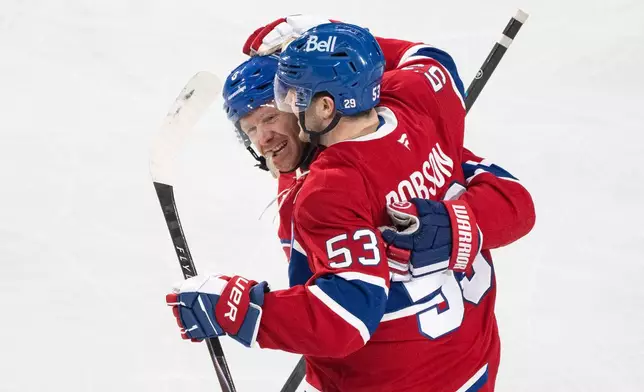 Montreal Canadiens' Noah Dobson (53) celebrates his goal over Florida Panthers with teammate Mike Matheson (8) during the first period of an NHL hockey game in Montreal, Thursday, Jan. 8, 2026. (Christinne Muschi/The Canadian Press via AP)