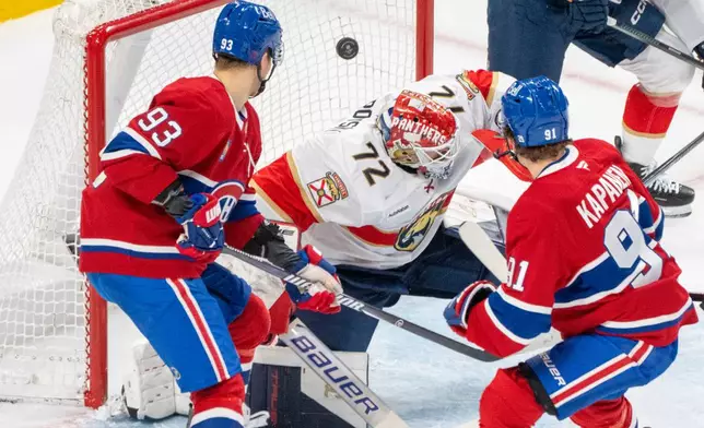 Montreal Canadiens' Oliver Kapanen (91) scores on Florida Panthers goaltender Sergei Bobrovsky (72) as teammate Ivan Demidov (93) looks on during the first period of an NHL hockey game in Montreal, Thursday, Jan. 8, 2026. (Christinne Muschi/The Canadian Press via AP)